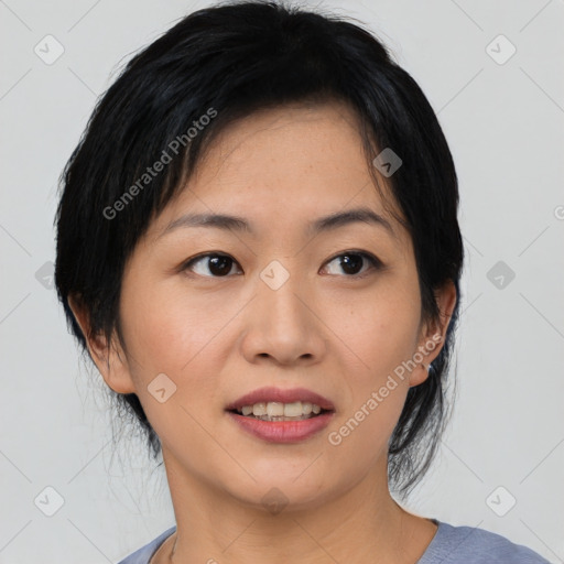 Joyful asian young-adult female with medium  black hair and brown eyes