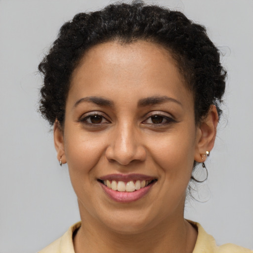 Joyful latino young-adult female with short  brown hair and brown eyes