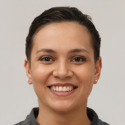 Joyful white young-adult female with short  brown hair and brown eyes
