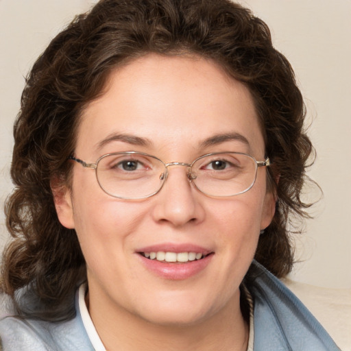 Joyful white adult female with medium  brown hair and green eyes