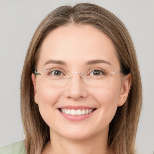 Joyful white young-adult female with long  brown hair and green eyes