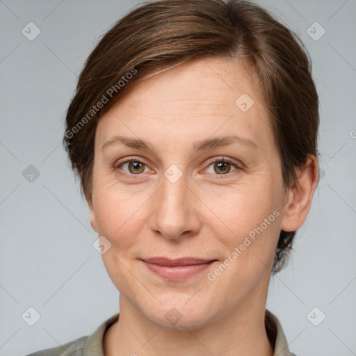 Joyful white adult female with short  brown hair and grey eyes