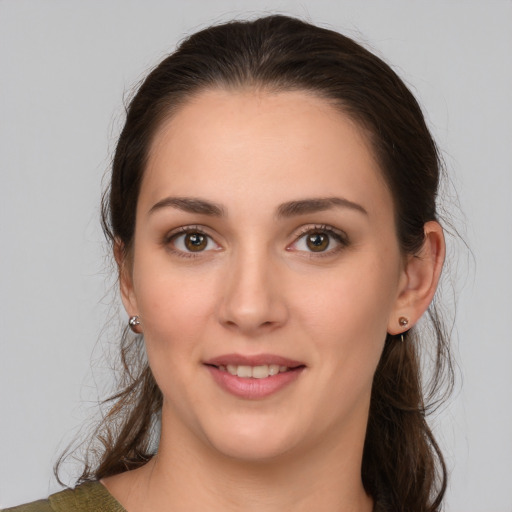 Joyful white young-adult female with medium  brown hair and brown eyes