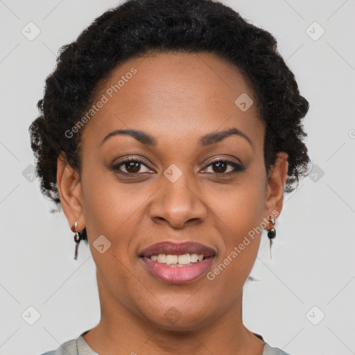 Joyful black adult female with short  brown hair and brown eyes