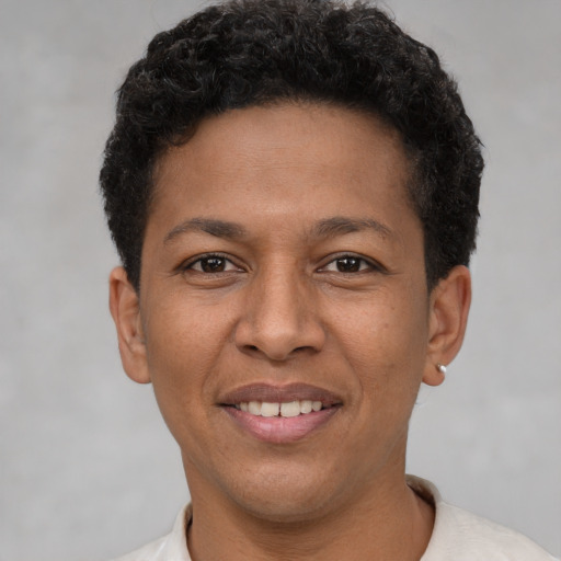 Joyful latino adult male with short  brown hair and brown eyes