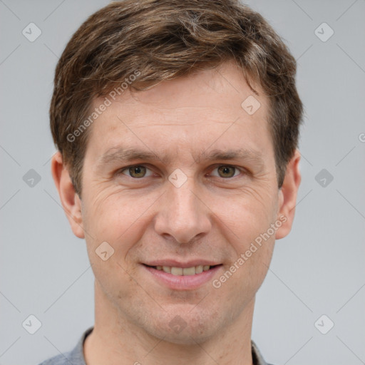 Joyful white adult male with short  brown hair and grey eyes