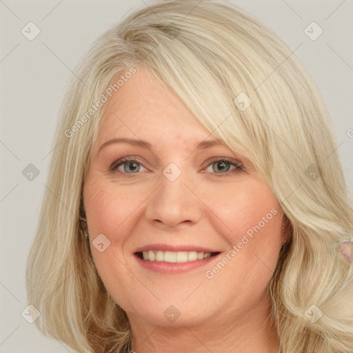 Joyful white young-adult female with long  blond hair and blue eyes