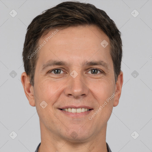 Joyful white adult male with short  brown hair and brown eyes