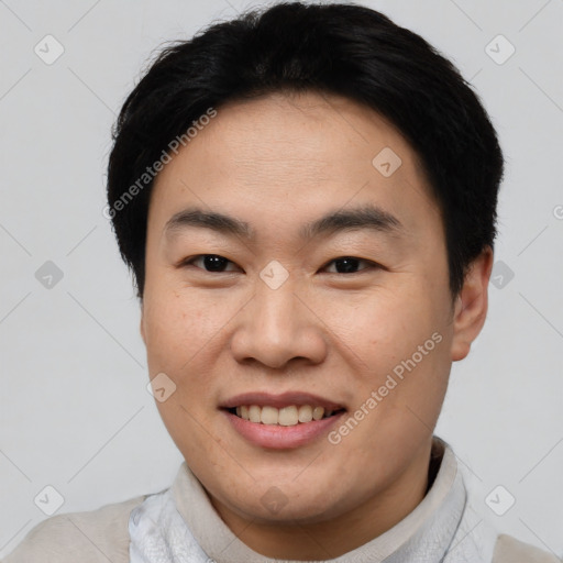 Joyful asian young-adult male with short  brown hair and brown eyes