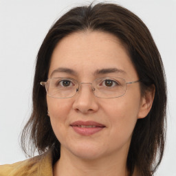 Joyful white adult female with medium  brown hair and brown eyes