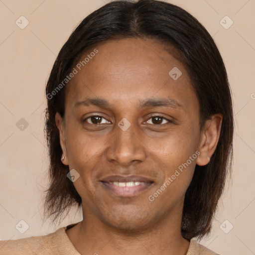 Joyful latino adult female with medium  brown hair and brown eyes