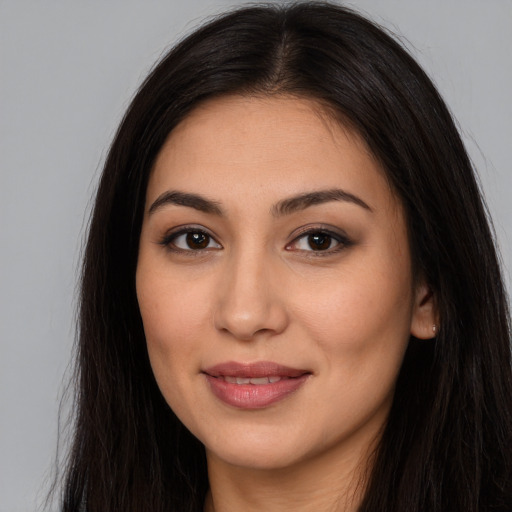 Joyful latino young-adult female with long  brown hair and brown eyes