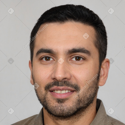 Joyful white young-adult male with short  black hair and brown eyes