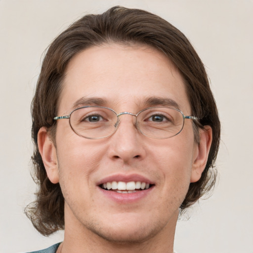 Joyful white adult male with medium  brown hair and grey eyes