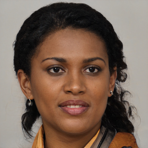 Joyful black young-adult female with medium  brown hair and brown eyes
