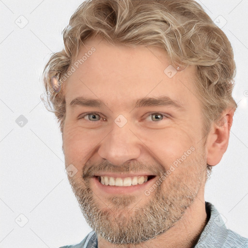 Joyful white adult male with short  brown hair and grey eyes