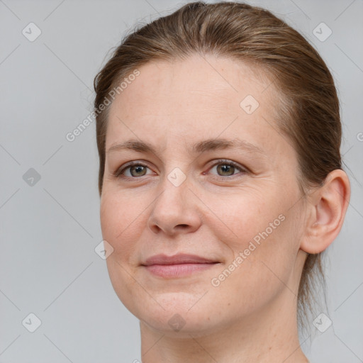 Joyful white adult female with medium  brown hair and grey eyes