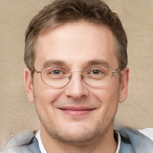 Joyful white adult male with short  brown hair and grey eyes