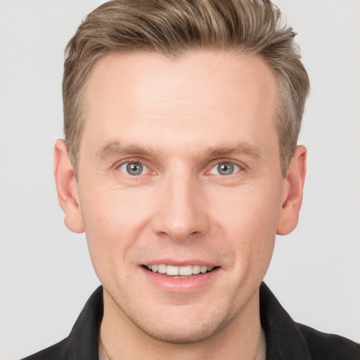 Joyful white adult male with short  brown hair and grey eyes