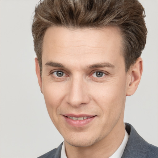 Joyful white adult male with short  brown hair and brown eyes