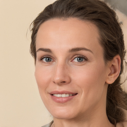 Joyful white young-adult female with medium  brown hair and brown eyes