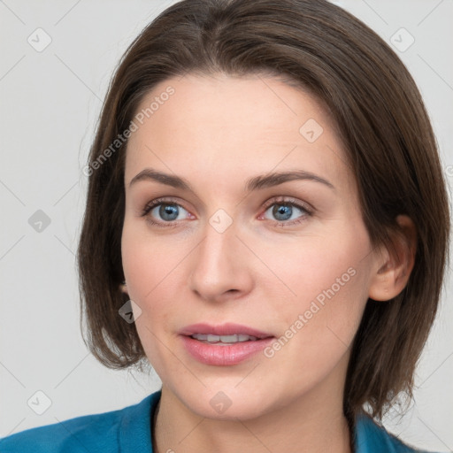 Joyful white young-adult female with medium  brown hair and grey eyes