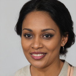 Joyful black young-adult female with medium  brown hair and brown eyes