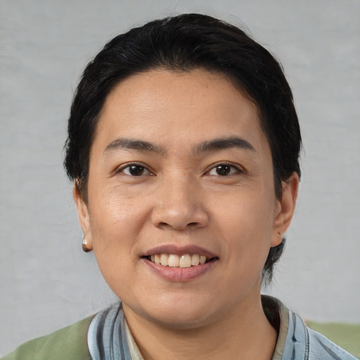 Joyful white young-adult female with short  black hair and brown eyes