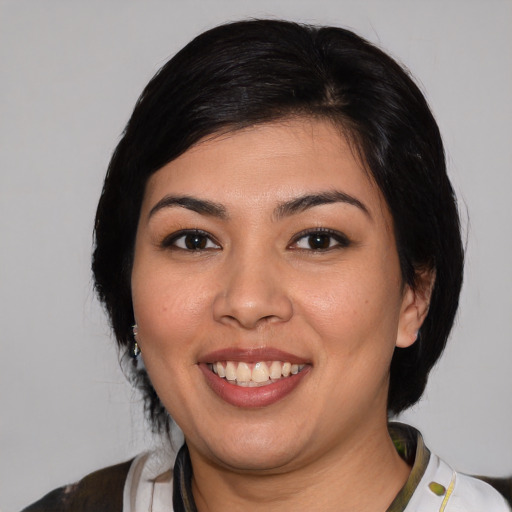 Joyful latino young-adult female with medium  black hair and brown eyes