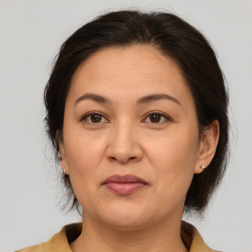 Joyful white adult female with medium  brown hair and brown eyes