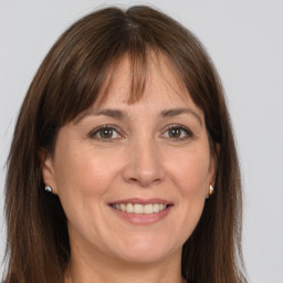 Joyful white adult female with long  brown hair and grey eyes