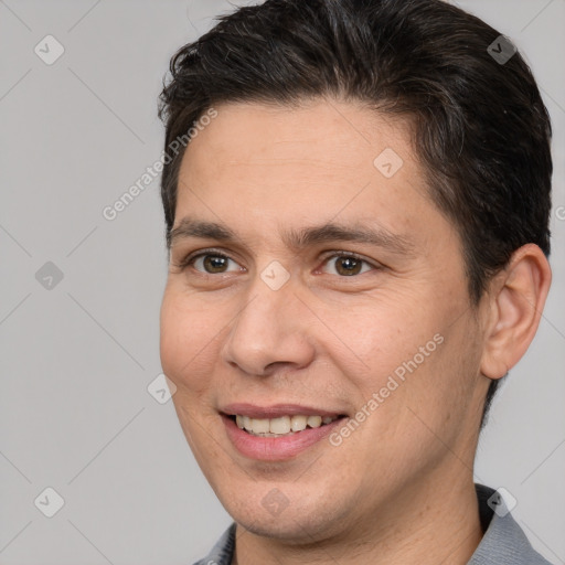 Joyful white adult male with short  brown hair and brown eyes