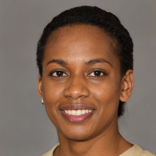 Joyful latino young-adult female with short  black hair and brown eyes