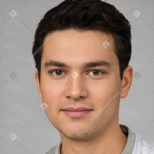 Joyful white young-adult male with short  black hair and brown eyes