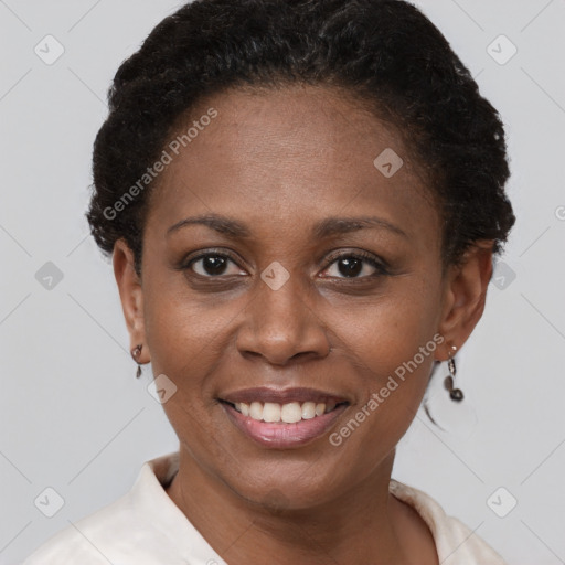 Joyful black adult female with short  brown hair and brown eyes