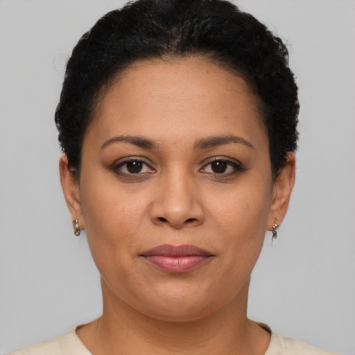 Joyful latino young-adult female with short  brown hair and brown eyes