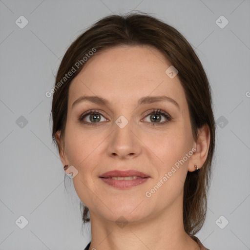 Joyful white adult female with medium  brown hair and grey eyes