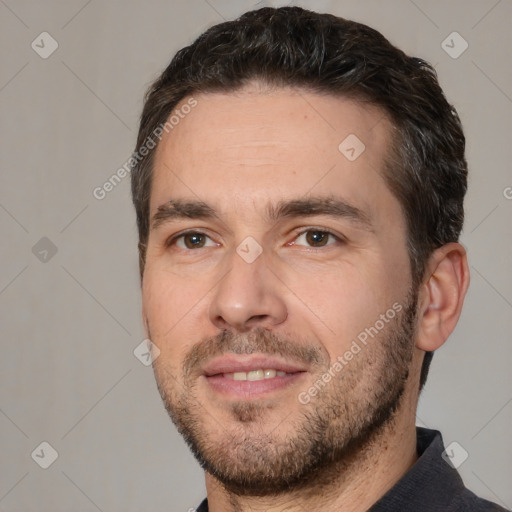 Joyful white adult male with short  black hair and brown eyes