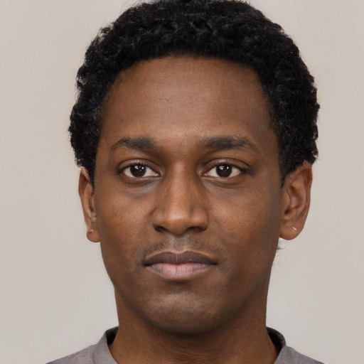 Neutral black young-adult male with short  black hair and brown eyes