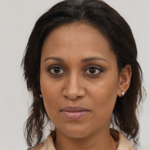 Joyful black young-adult female with medium  brown hair and brown eyes