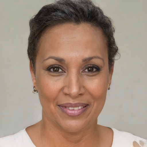 Joyful black adult female with short  brown hair and brown eyes