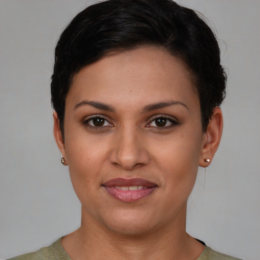 Joyful latino young-adult female with short  brown hair and brown eyes
