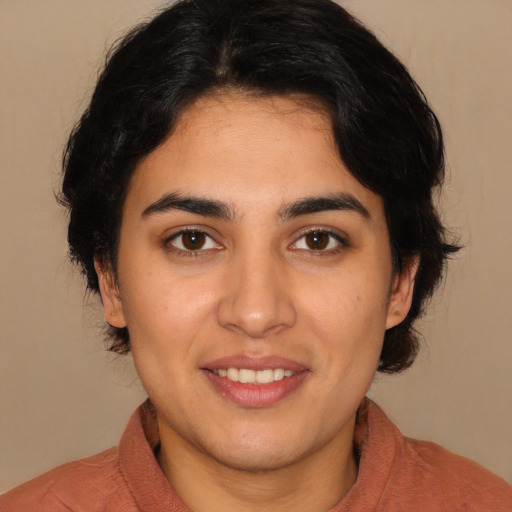 Joyful latino young-adult female with medium  brown hair and brown eyes