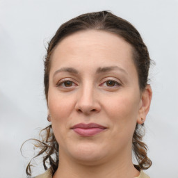 Joyful white adult female with long  brown hair and grey eyes