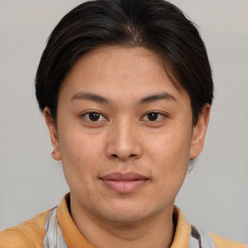 Joyful asian young-adult female with short  brown hair and brown eyes