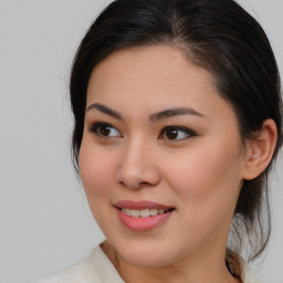 Joyful asian young-adult female with medium  brown hair and brown eyes