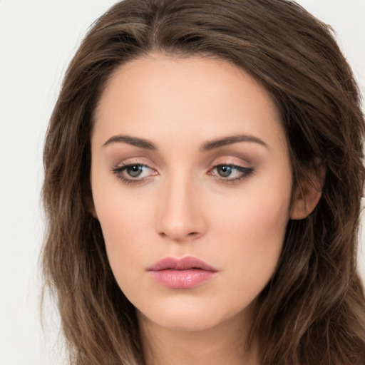 Neutral white young-adult female with long  brown hair and brown eyes