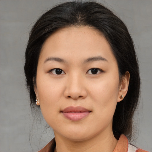 Joyful asian young-adult female with medium  brown hair and brown eyes