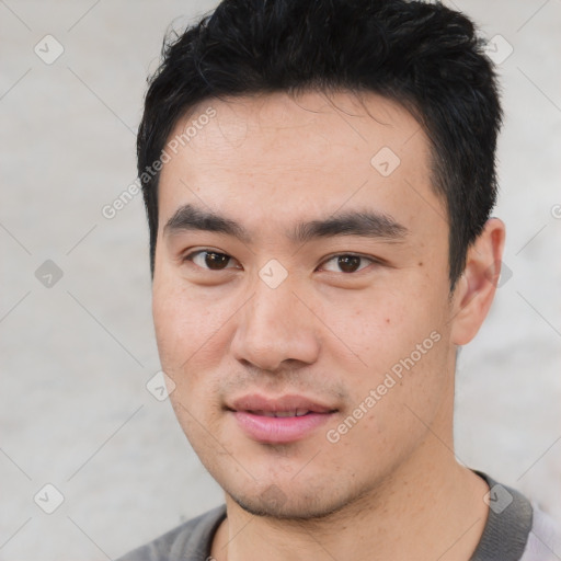 Joyful asian young-adult male with short  black hair and brown eyes