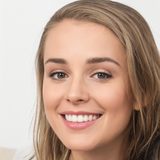 Joyful white young-adult female with long  brown hair and green eyes